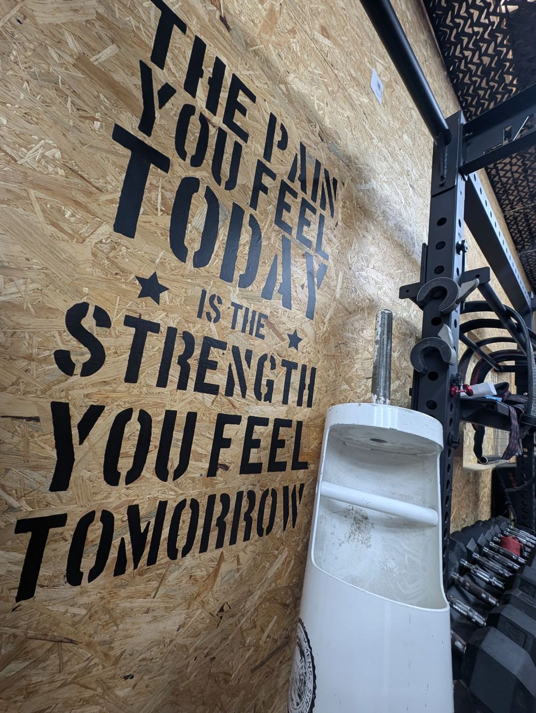 Stencilled wall: The pain you feel today is the strength you feel tomorrow